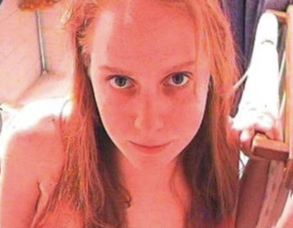 Jennifer Ringley red lighting webcam portrait with retro internet aesthetic