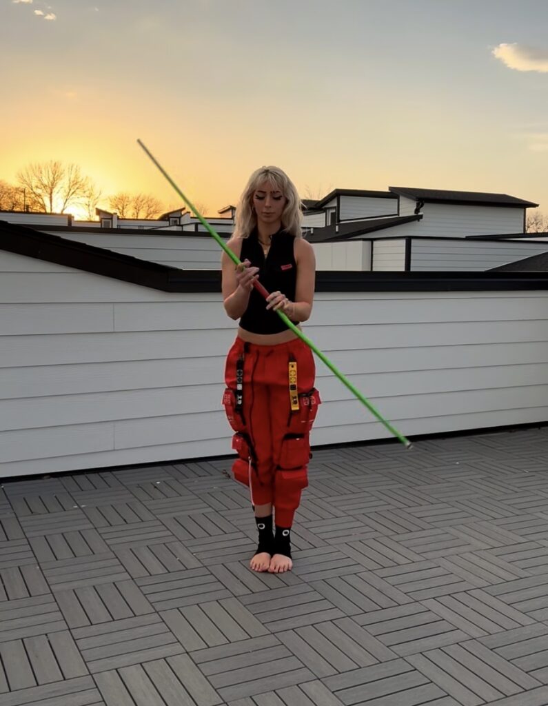 Nala Ray rooftop fashion portrait in red outfit with luxury influencer vibe
