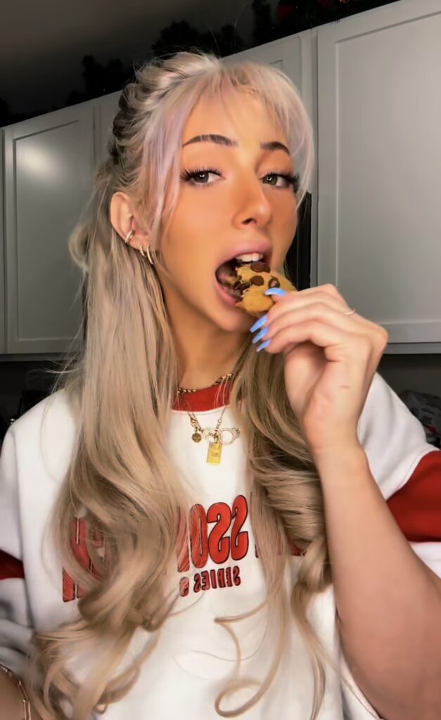 Nala Ray casual lifestyle portrait eating snack with glamorous influencer style