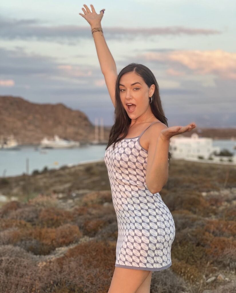 Sasha Grey posing near coastal landscape in luxury fashion influencer photoshoot